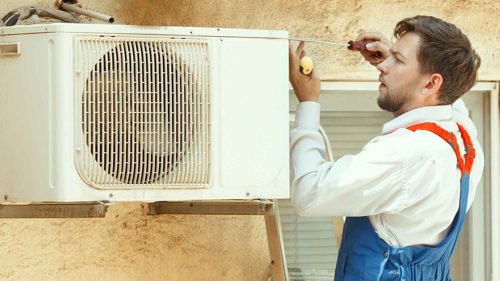 AC repair technician servicing outdoor unit